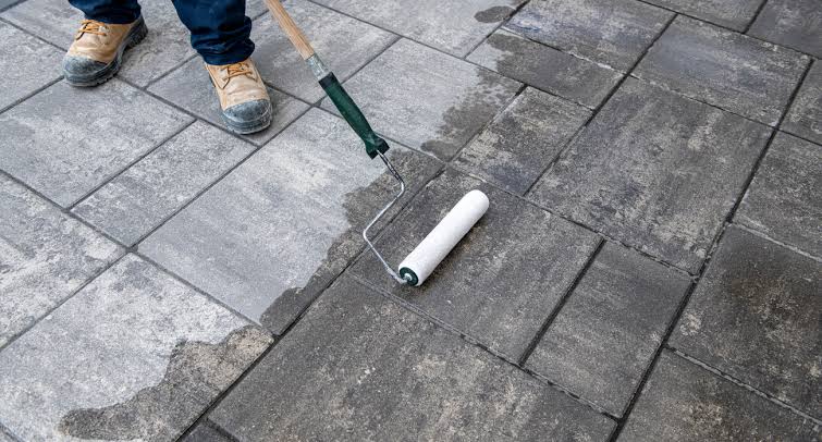 Applying paver sealer with a roller