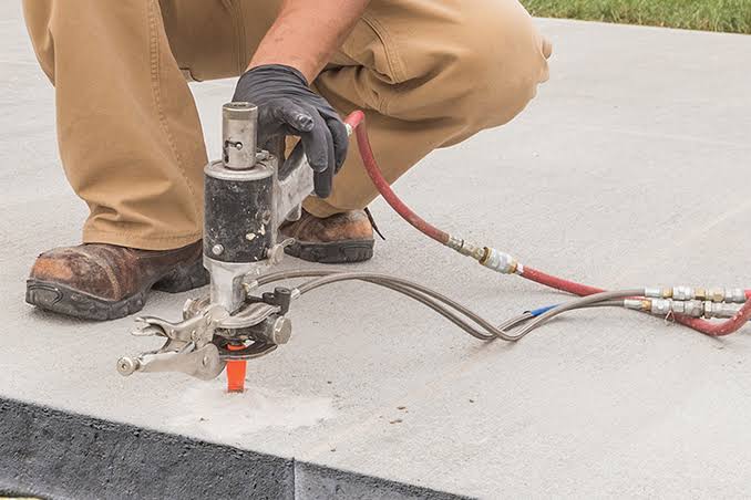 Close-up of slab lifting port drilled into concrete